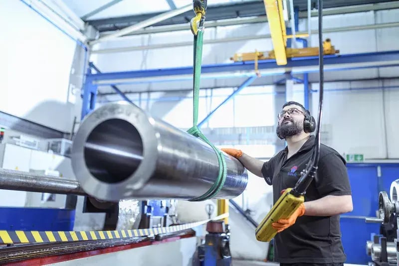 An engineer using a part made by precision deep hole boring.