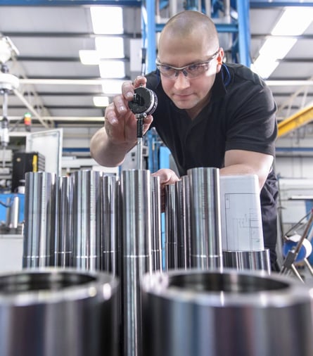 A man figuring out wall thickness during deep hole boring