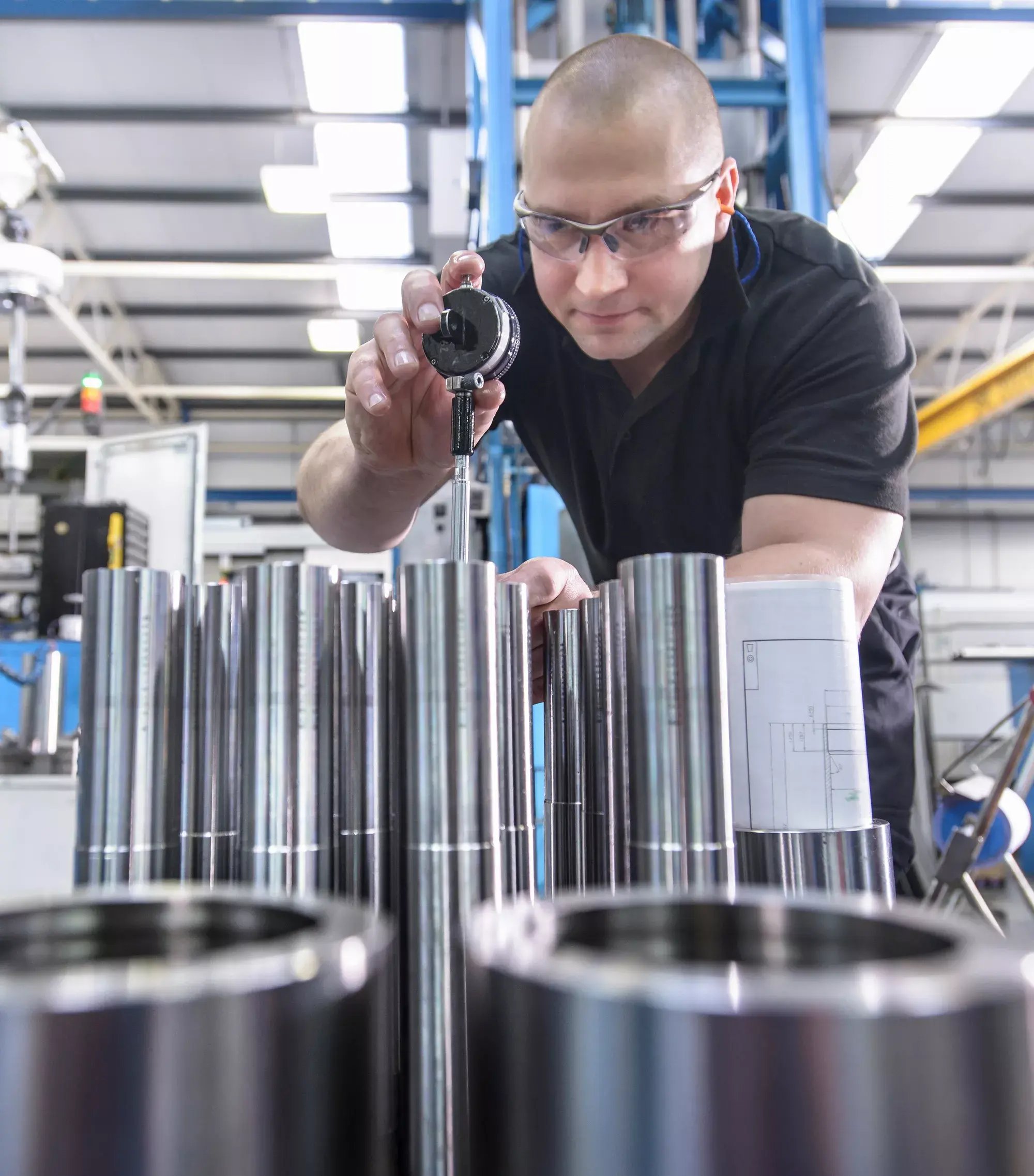 An engineer testing parts made by precision rollers.