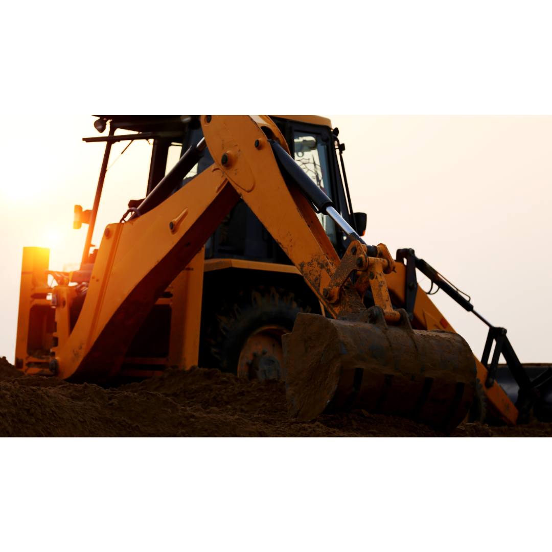A backhoe loader with a bucket full of soil, captured against a dusky sky, indicating either early morning or late evening work hours on a construction or excavation site.