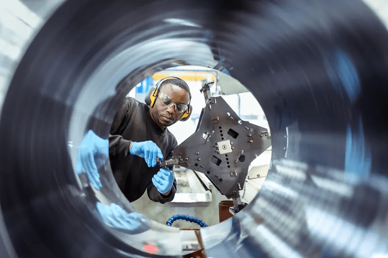 A man making the last steps of the honing process to enhance the quality of the components manufactured.